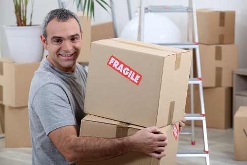 Moving boxes and a removals van for a home move in Colindale