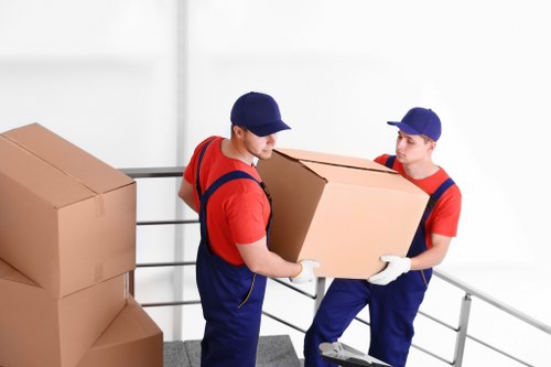 Man and van loading furniture in Colindale near modern apartments