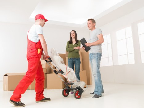 Trained moving staff handling boxes and furniture carefully