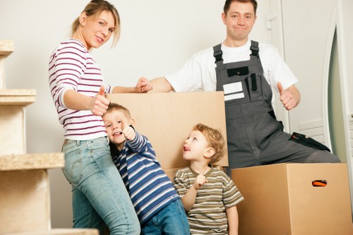 Local Colindale movers navigating a residential street with packed boxes